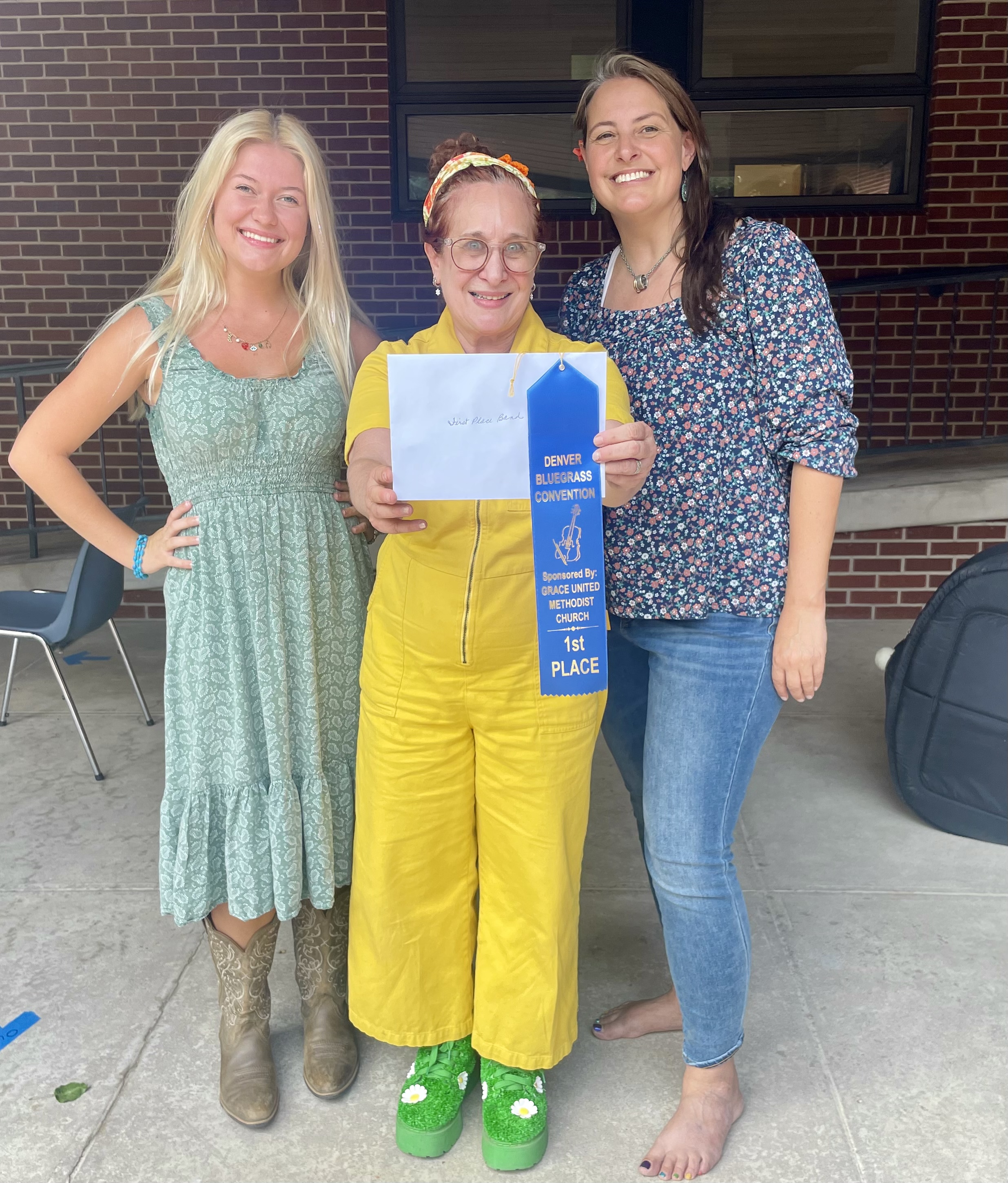 Haven, Sharon holding blue ribbon and Franziska at Denver Bluegrass Convention