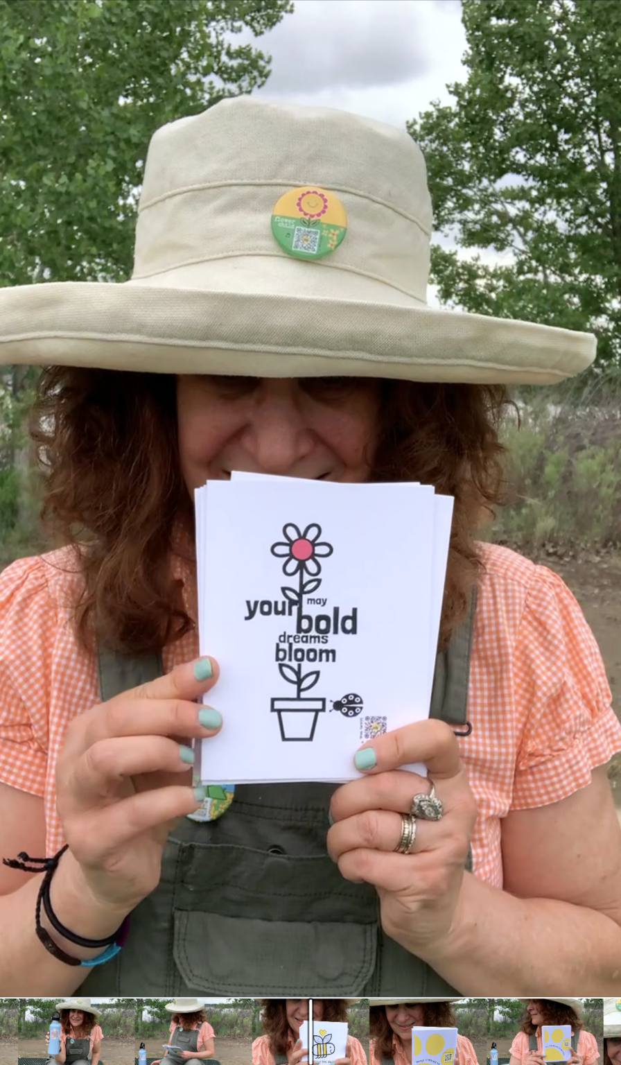woman with sunhat holding greeting cards with flowers